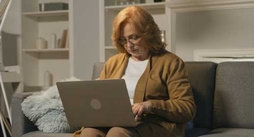 Older woman working from her laptop.