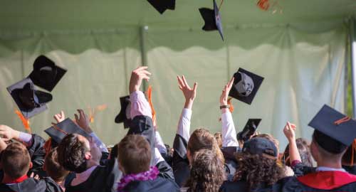 Graduates throwing hats in the air.