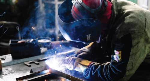 A person welding metal.